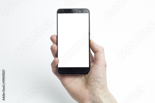 A man's hand holding a smartphone on a white background. Touching screen.