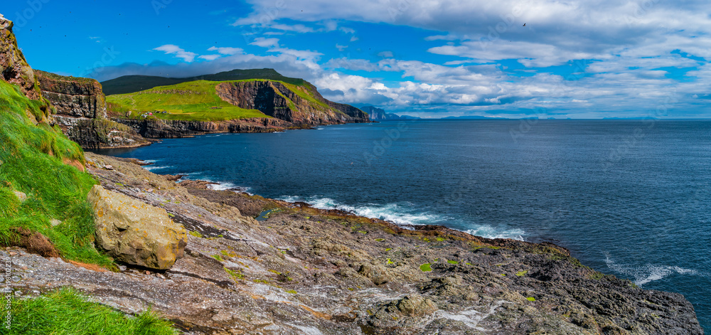 Panoramic view of Mykines at Faroe islands and North Atlantic puffins
