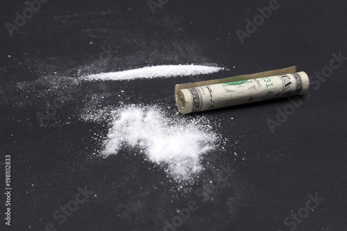 Cocaine lines with rolled up dollar bill
