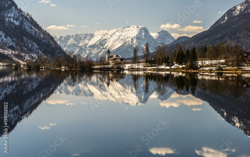 Sunny winter Alpine lake Grundlsee (Styria, Austria) with fantastic reflection on the water surface.