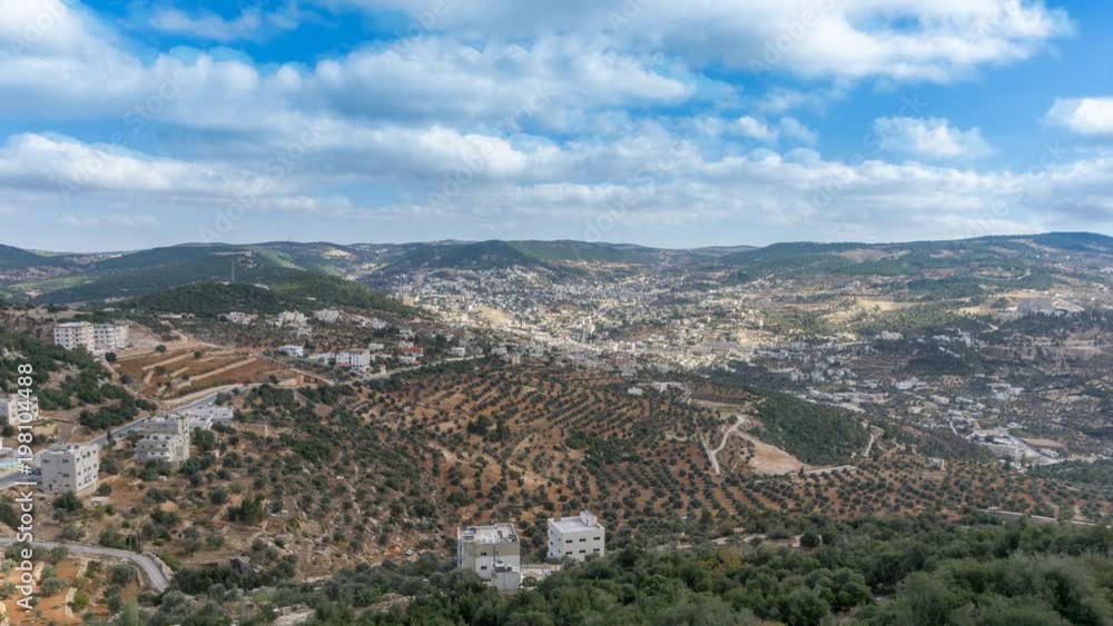 Cinemagraph of a cloudscape over olive orchards in the Jordan valley in an infinite and seemless loop Cinemagraph of a cloudscape over olive orchards in the Jordan valley in an infinite and seemless loop