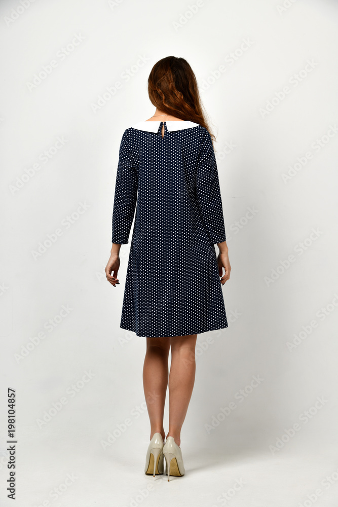 Young beautiful woman posing in new casual black and white dotted dress Young beautiful woman posing in new casual black and white dotted dress