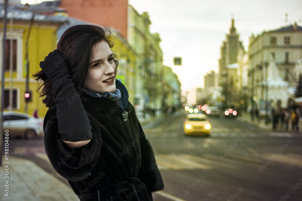 Fototapeta premium young gild walking in the europe street with traffic on background