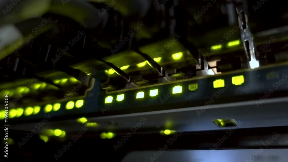 MOSCOW, RUSSIA - March 26: Modern network switch with cables. Flashing server lamp, switch, router. Severs computer in a rack at the large data center. March 26. Editorial MOSCOW, RUSSIA - March 26: Modern network switch with cables. Flashing server lamp, switch, router. Severs computer in a rack at the large data center. March 26. Editorial
