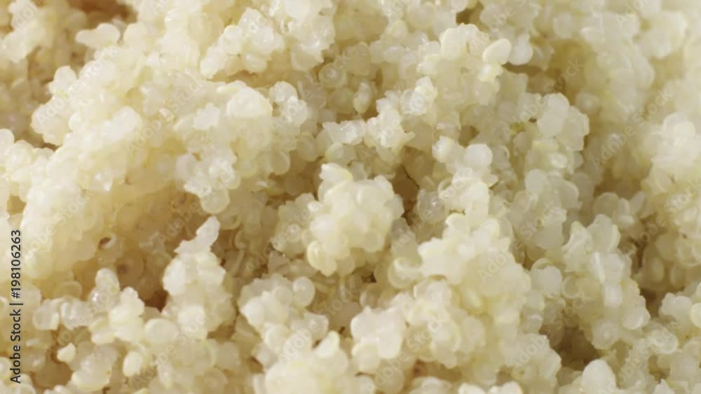 Tracking shot of a big healthy bowl of cooked quinoa in slow motion. Tracking shot of a big healthy bowl of cooked quinoa in slow motion.