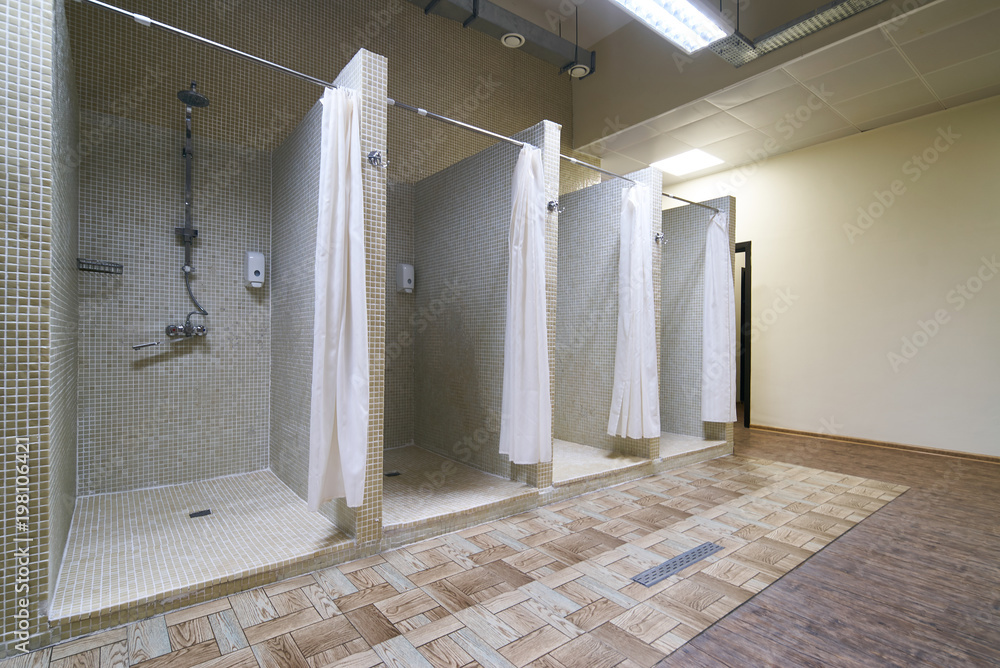 Public Shower Interior With Everal Showers And Lockers In Locker Room 
