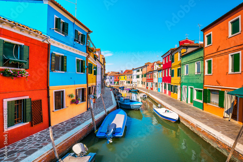 Venice landmark, Burano island canal, colorful houses and boats, Italy © stevanzz