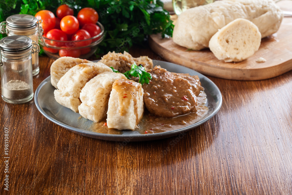 Pork loin in gravy with bread dumplings and sauerkraut Pork loin in gravy with bread dumplings and sauerkraut