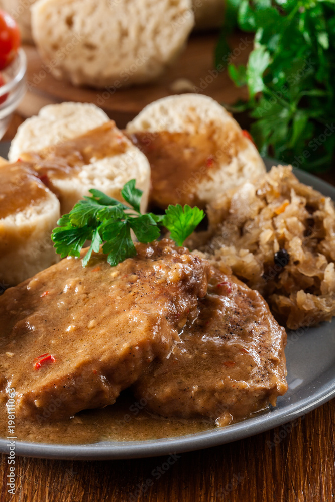 Pork loin in gravy with bread dumplings and sauerkraut Pork loin in gravy with bread dumplings and sauerkraut