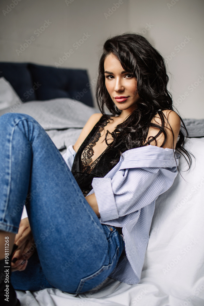 cute young woman sitting on the floor in blue jeans and blue shirt, fashion cute young woman sitting on the floor in blue jeans and blue shirt, fashion