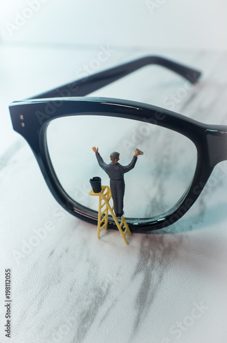 Tiny Figurine Cleans Eye Glasses photo