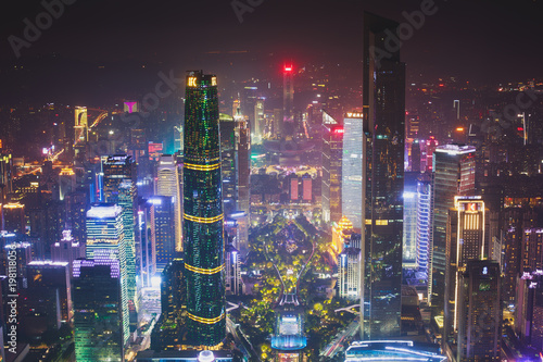 Beautiful wide-angle night aerial view of Guangzhou Zhujiang New Town financial district, Guangdong, China with skyline and scenery beyond the city, seen from the observation deck of Canton Tower
 photo