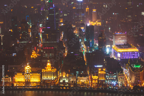 Beautiful super wide-angle night aerial view of Shanghai, China with Waitan, The Bund and scenery beyond the city, seen from the observation deck of Oriental Pearl TV Tower © tsuguliev