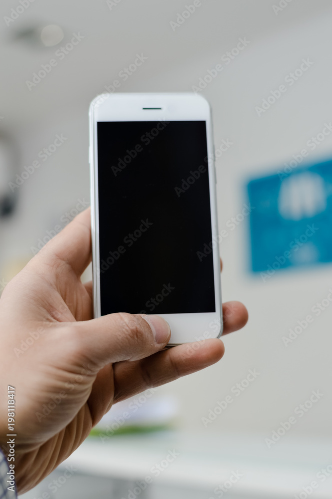 Hand hold mobile phone, person using smartphone. Top view closeup on black screen digital device mock up. Marketing technology design surface background, communication lifestyle Hand hold mobile phone, person using smartphone. Top view closeup on black screen digital device mock up. Marketing technology design surface background, communication lifestyle