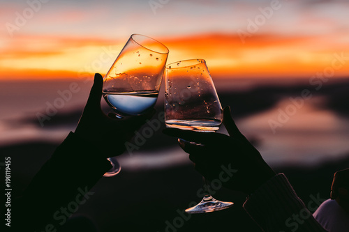 Fototapeta Naklejka Na Ścianę i Meble -  drinking wine at sunset