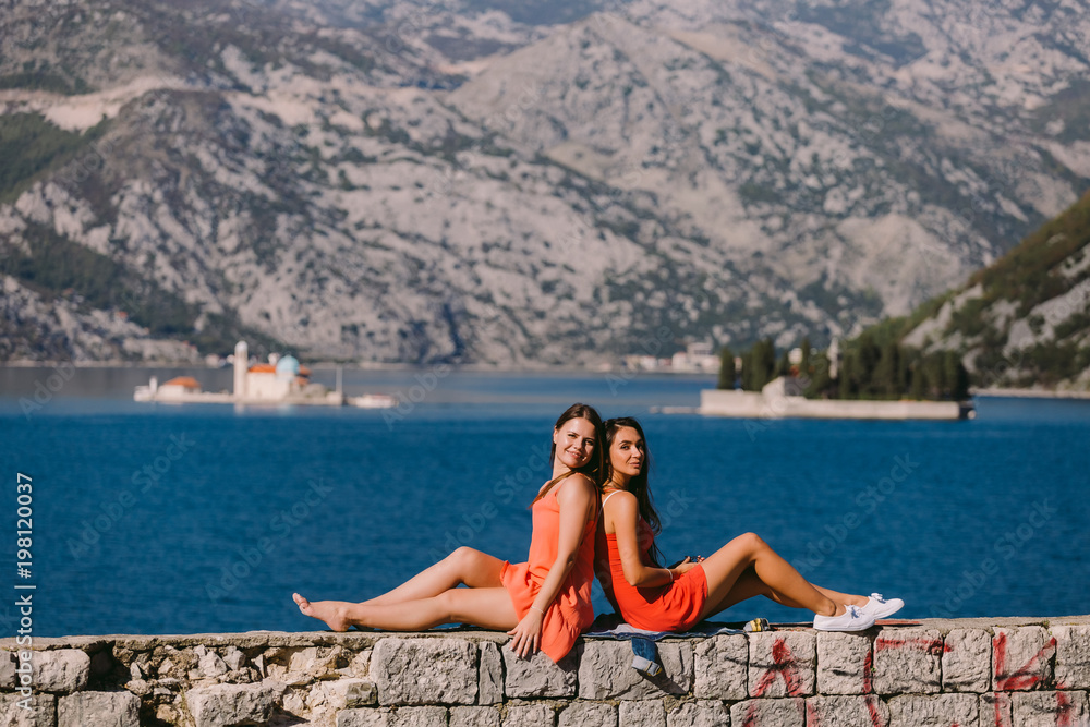 two girls travelling sea and mountains view in Montenegro