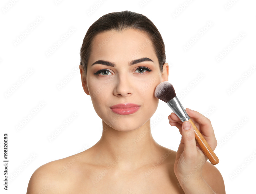 Visage artist applying makeup on woman's face against white background. Professional cosmetic products Visage artist applying makeup on woman's face against white background. Professional cosmetic products