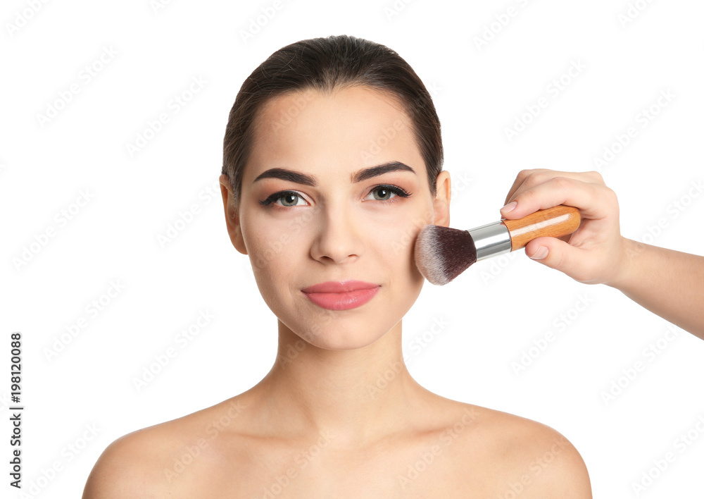 Visage artist applying makeup on woman's face against white background. Professional cosmetic products Visage artist applying makeup on woman's face against white background. Professional cosmetic products