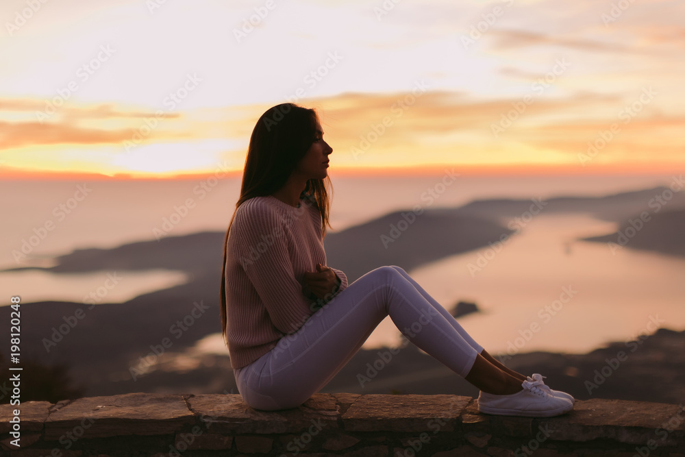 woman dreaming at sunset with mountains view