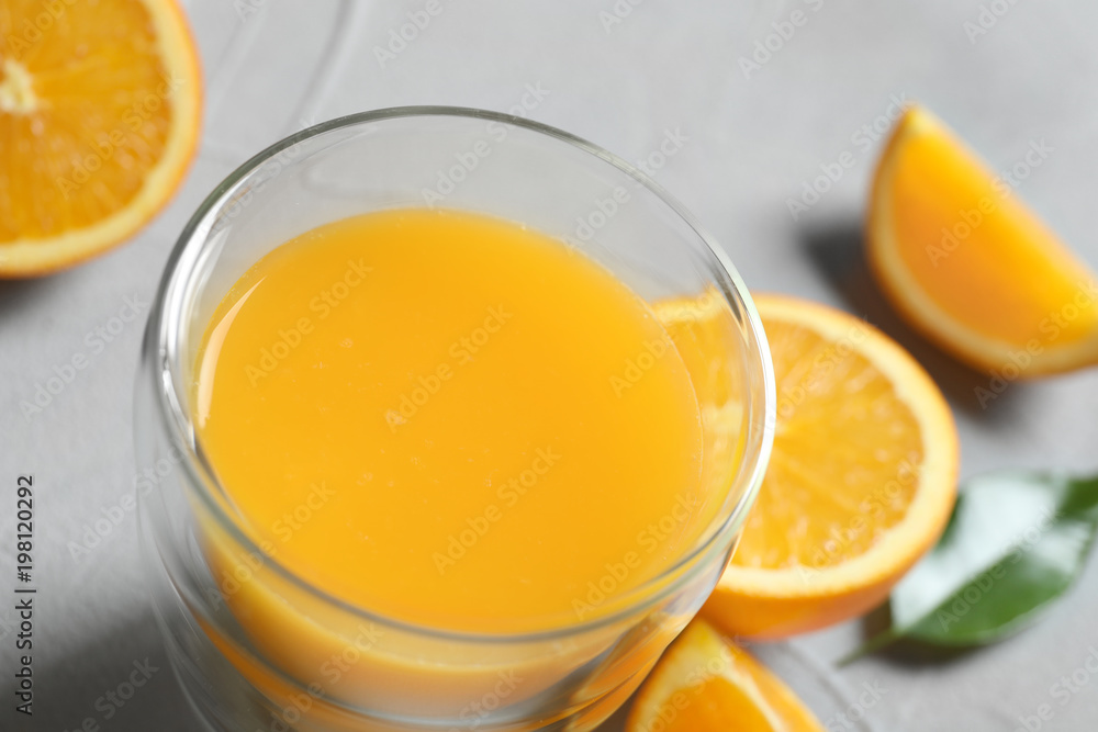 Glass of orange juice and fresh fruits on table, closeup Glass of orange juice and fresh fruits on table, closeup