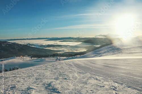 Ski slope at snowy resort on winter day