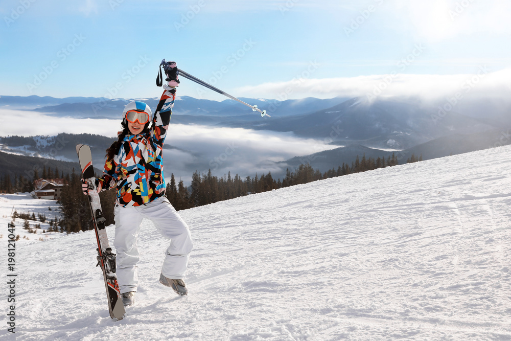 Happy woman on ski piste at snowy resort. Winter vacation Happy woman on ski piste at snowy resort. Winter vacation