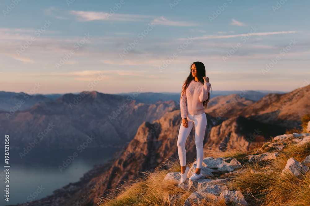 Fototapeta premium woman relax in mountains at sunset