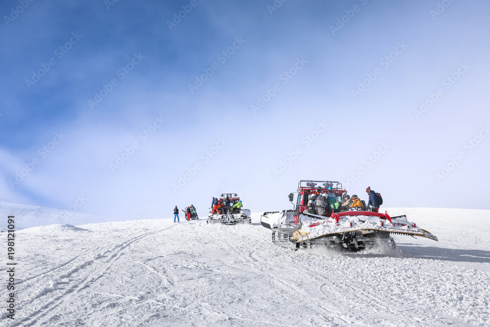 Tourists on ski piste at snowy resort. Winter vacation Tourists on ski piste at snowy resort. Winter vacation