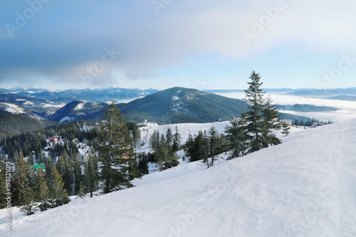 Snowy ski resort in mountains on winter day