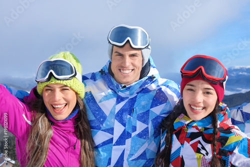 Happy friends at ski resort. Winter vacation