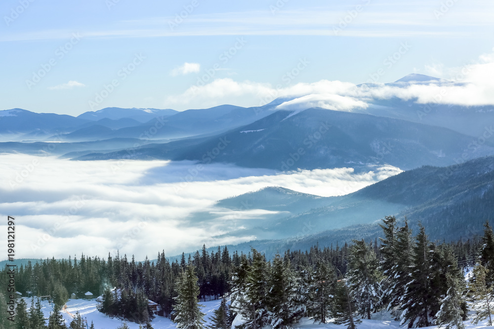 Beautiful landscape with foggy mountains in wintertime