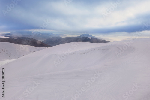Ski slope at snowy resort on winter day © Africa Studio