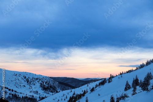 Beautiful landscape with snowy mountains in winter evening
