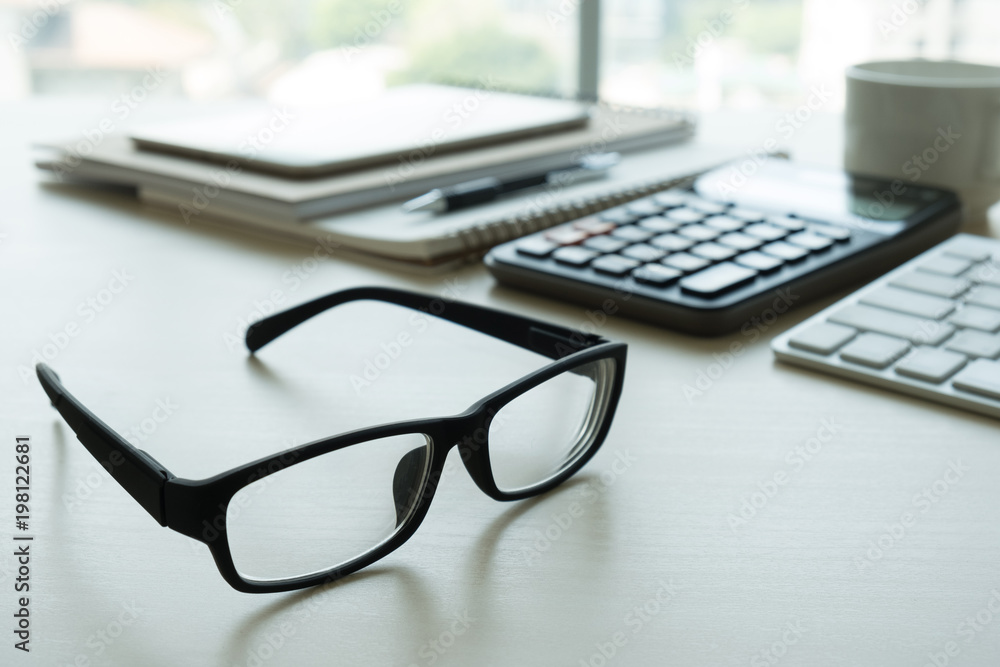 Close up of glasses and computer business workplace work place in office Close up of glasses and computer business workplace work place in office