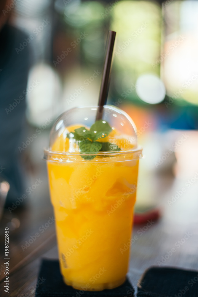 Orange juice smoothie glass on wood table