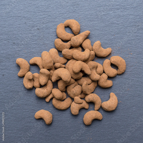 Cashew nuts covered with cocoa powder, close up . Balinese dessert, Indonesia, island Bali
