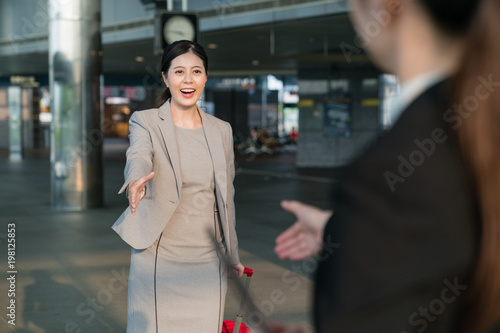 Businesswomen going to shake hands.