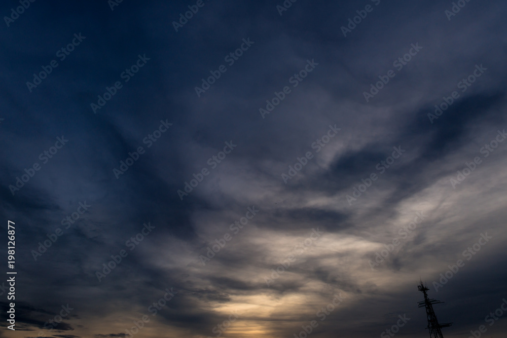 Fototapeta premium Silhouette of cellular tower with beautiful sunset cloudy sky