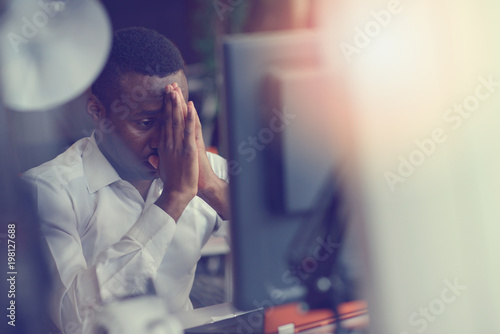 Canvas Print Stressed tired freelancer is having headache and thinking how to finish his work