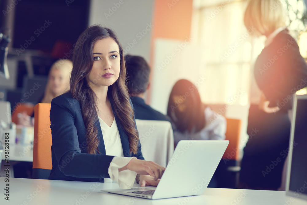 Image of woman using laptop while sitting at her desk. Image of woman using laptop while sitting at her desk.