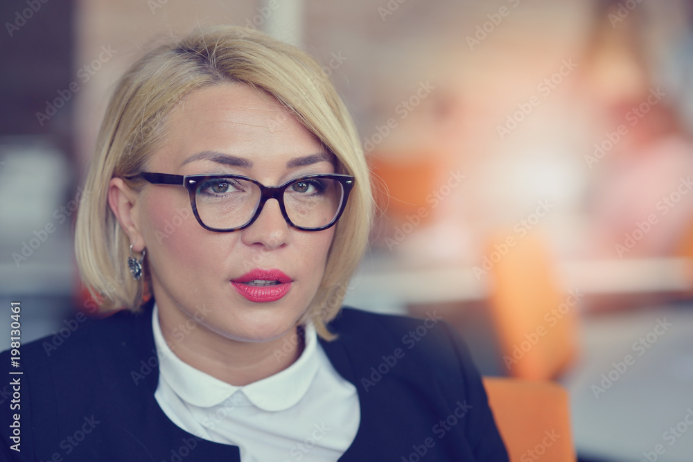 Portrait of cheerful blond woman in office Portrait of cheerful blond woman in office