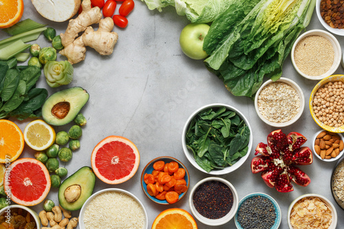 Top view clean eating concept. Frame of vegetarian healthy food - different vegetables and fruits  superfood  seeds  cereal  leaf vegetable on white background. Flat lay