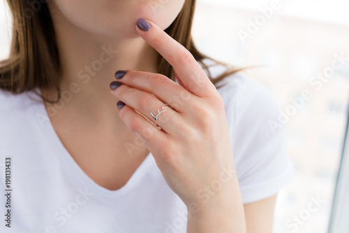 Beautiful young woman wearing a silver ring