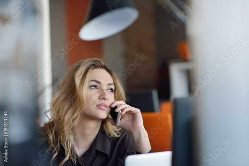 Portrait of cheerful employer of business enterprise enjoying creative working process in modern office indoors photo