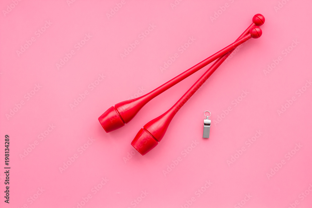Maces for rhythmic gymnastics on pink background top view copy space Maces for rhythmic gymnastics on pink background top view copy space