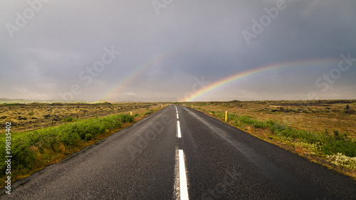 Double rainbow over barren Icelandic highway