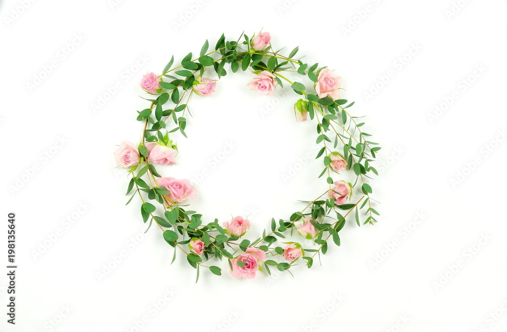 Flowers background. Wreath frame made of pale pink roses flowers and eucalyptus branches on a white background. Flat lay. top view. copy space Flowers background. Wreath frame made of pale pink roses flowers and eucalyptus branches on a white background. Flat lay. top view. copy space