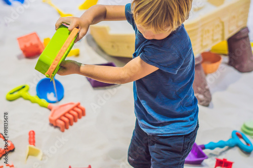 Fotografie Boy playing with sand in preschool