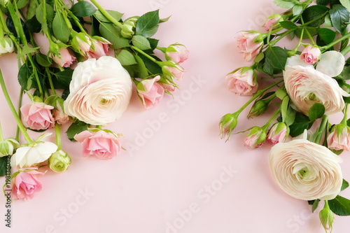 beautiful bouquet of gently pink roses and ranunculus on a pale pink background. close up. top view.copy space