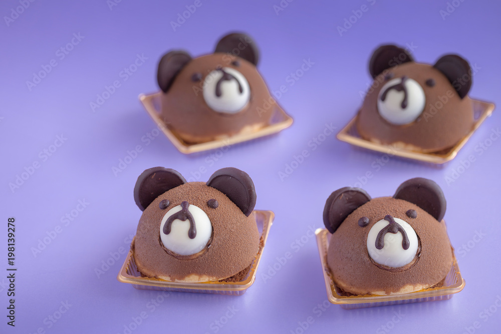 Brown Teddy Bear's Head Chocolate Chiffon Cake on a violet background and copy space Brown Teddy Bear's Head Chocolate Chiffon Cake on a violet background and copy space